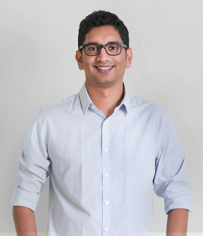 Dev Man with glasses in shirt smiling